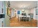 Bright dining room featuring hardwood floors, a modern chandelier, and a view into the hallway at 2115 Wappoo Dr, Charleston, SC 29412