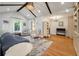 Bright living room boasts vaulted ceiling, wood floors, area rug and stylish furnishings at 2115 Wappoo Dr, Charleston, SC 29412