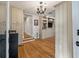 Open-concept living room featuring hardwood floors, built-in bookshelves, and an adjacent hallway at 2115 Wappoo Dr, Charleston, SC 29412