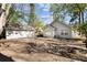 The backyard shows the detached garage and a mostly cleared lot with a mix of sun and shade from trees at 25 Oak Forest Dr, Charleston, SC 29407