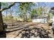 Spacious backyard featuring a detached garage, a chain-link fence, and mature trees providing plenty of shade at 25 Oak Forest Dr, Charleston, SC 29407