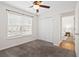This bedroom features neutral carpet, a ceiling fan with a light fixture and a window bringing in natural light at 25 Oak Forest Dr, Charleston, SC 29407