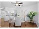 Bright dining area with a glass table, neutral chairs, wood floors, and an open layout to the kitchen at 25 Oak Forest Dr, Charleston, SC 29407