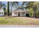 Charming one-story home with a front porch and well-manicured lawn, creating a welcoming curb appeal at 25 Oak Forest Dr, Charleston, SC 29407