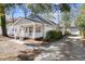 Lovely home with a welcoming front porch, a detached garage, and a neatly kept driveway at 25 Oak Forest Dr, Charleston, SC 29407