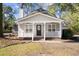 Charming home boasting a welcoming porch with a white railing and a black front door, enhancing curb appeal at 25 Oak Forest Dr, Charleston, SC 29407