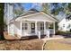 Charming home showcasing a welcoming front porch with white railings, perfect for enjoying the outdoors at 25 Oak Forest Dr, Charleston, SC 29407