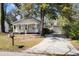 Lovely home featuring a charming front porch, a detached garage, and a neatly kept driveway at 25 Oak Forest Dr, Charleston, SC 29407