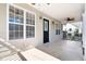 Inviting front porch with ample natural light, stylish lighting fixtures, and ceiling fans at 25 Oak Forest Dr, Charleston, SC 29407