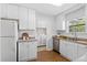 Bright kitchen offering white cabinetry, stainless steel appliances, and convenient access to the laundry area at 25 Oak Forest Dr, Charleston, SC 29407
