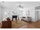 Bright living room featuring a cozy fireplace, stylish decor, and hardwood floors at 25 Oak Forest Dr, Charleston, SC 29407