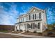 Charming two-story home with black shutters, landscaped yard, and a bright blue sky at 209 Abercom Place Dr, Moncks Corner, SC 29461