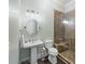 Modern bathroom featuring a glass shower, pedestal sink, and updated fixtures for a sleek and functional space at 3003 Yachtsman Dr, Mount Pleasant, SC 29466