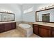 Well-lit bathroom with double vanities and a soaking tub with stylish tile surround at 3003 Yachtsman Dr, Mount Pleasant, SC 29466