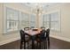 Bright dining room features an updated lighting fixture, hardwood floors, and lots of natural light from large windows at 3003 Yachtsman Dr, Mount Pleasant, SC 29466