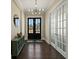 Welcoming foyer with dark wood floors, a modern light fixture, and double doors leading to the exterior at 3003 Yachtsman Dr, Mount Pleasant, SC 29466