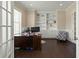 Well-lit home office with dark wood floors, custom built-ins, and a neutral color palette at 3003 Yachtsman Dr, Mount Pleasant, SC 29466