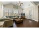 Cozy living room with vaulted ceiling, large windows, hardwood floors, and comfortable seating, perfect for relaxation at 3003 Yachtsman Dr, Mount Pleasant, SC 29466