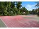Outdoor basketball court with lighting, bordered by green vegetation, providing a recreational area for residents at 303 Lakeside Dr # C-2, Mount Pleasant, SC 29464