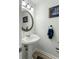 Chic powder room with a pedestal sink, ship themed art and modern lighting at 303 Lakeside Dr # C-2, Mount Pleasant, SC 29464