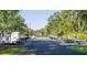 Community boat storage area with various boats and trailers parked on a paved lot, near a fenced-in tennis court at 303 Lakeside Dr # C-2, Mount Pleasant, SC 29464
