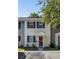 A charming two-story townhome featuring a red door, black shutters, and a well-maintained landscape at 303 Lakeside Dr # C-2, Mount Pleasant, SC 29464