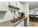 Modern kitchen featuring white subway tile, stainless steel appliances, and a view into the dining room at 303 Lakeside Dr # C-2, Mount Pleasant, SC 29464