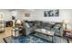 Spacious living room featuring a gray sectional sofa, patterned rug, and stylish decor at 303 Lakeside Dr # C-2, Mount Pleasant, SC 29464