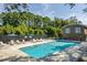 Community pool with lounge chairs and shade umbrellas for relaxation at 303 Lakeside Dr # C-2, Mount Pleasant, SC 29464
