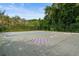 A community recreation area featuring a shuffleboard court with a building and tennis court in the background at 303 Lakeside Dr # C-2, Mount Pleasant, SC 29464