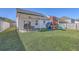 Spacious backyard featuring a covered patio with outdoor seating and a charming playset, perfect for Gathering enjoyment at 311 Citation Way, Moncks Corner, SC 29461
