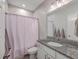 Neutral-colored bathroom with granite vanity, shower with curtain, and toilet at 311 Citation Way, Moncks Corner, SC 29461
