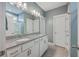 Bright bathroom with double sink vanity, granite countertop, and white cabinets at 311 Citation Way, Moncks Corner, SC 29461