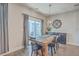 Cozy dining area with rustic wooden table, modern lighting, and sliding glass doors to outdoor patio at 311 Citation Way, Moncks Corner, SC 29461