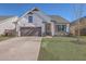 Charming single-Gathering home featuring a well-manicured lawn and attached two-car garage at 311 Citation Way, Moncks Corner, SC 29461