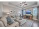 Cozy living room with a plush sectional sofa, ceiling fan, and tray ceiling at 311 Citation Way, Moncks Corner, SC 29461