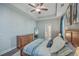 Main bedroom with tray ceilings, a wood dresser, a large bed, and neutral colors at 311 Citation Way, Moncks Corner, SC 29461