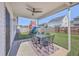 Covered patio with a table, ceiling fan, and a view of the backyard playground at 311 Citation Way, Moncks Corner, SC 29461