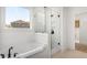 Well-lit bathroom featuring a standalone tub, a glass-enclosed shower, and a window with a view at 325 Abercom Place Dr, Moncks Corner, SC 29461