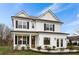 Beautiful two-story home with white siding, black shutters, and a welcoming front porch at 325 Abercom Place Dr, Moncks Corner, SC 29461