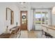 Bright foyer featuring a wood door, console table with a lamp, and view of the dining area at 325 Abercom Place Dr, Moncks Corner, SC 29461