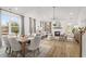 Open concept living and dining area with fireplace, lots of natural light, and hardwood floors at 325 Abercom Place Dr, Moncks Corner, SC 29461