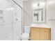 This bathroom features a glass shower, a wooden vanity, and a white framed mirror at 3316 Island Estates Dr, Johns Island, SC 29455