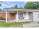 Cozy front porch features outdoor seating, brick accents and privacy fence for relaxed outdoor living at 3316 Island Estates Dr, Johns Island, SC 29455