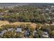 An expansive aerial view of the property surrounded by trees, featuring a nearby golf course at 3323 Myrtle St, Edisto Island, SC 29438