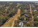 Aerial shot of the property next to golf course and surrounded by trees, marked with a yellow pin at 3323 Myrtle St, Edisto Island, SC 29438