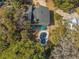 An aerial view of a home with a pool nestled in a wooded area at 3323 Myrtle St, Edisto Island, SC 29438
