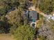Aerial view of the property with a backyard pool, surrounded by trees and close to a golf course at 3323 Myrtle St, Edisto Island, SC 29438