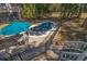 Aerial view of backyard pool, outdoor table and chairs, stairs, and surrounding trees at 3323 Myrtle St, Edisto Island, SC 29438