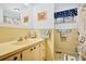 Quaint bathroom with seashell themed decor, vanity, and shower at 3323 Myrtle St, Edisto Island, SC 29438